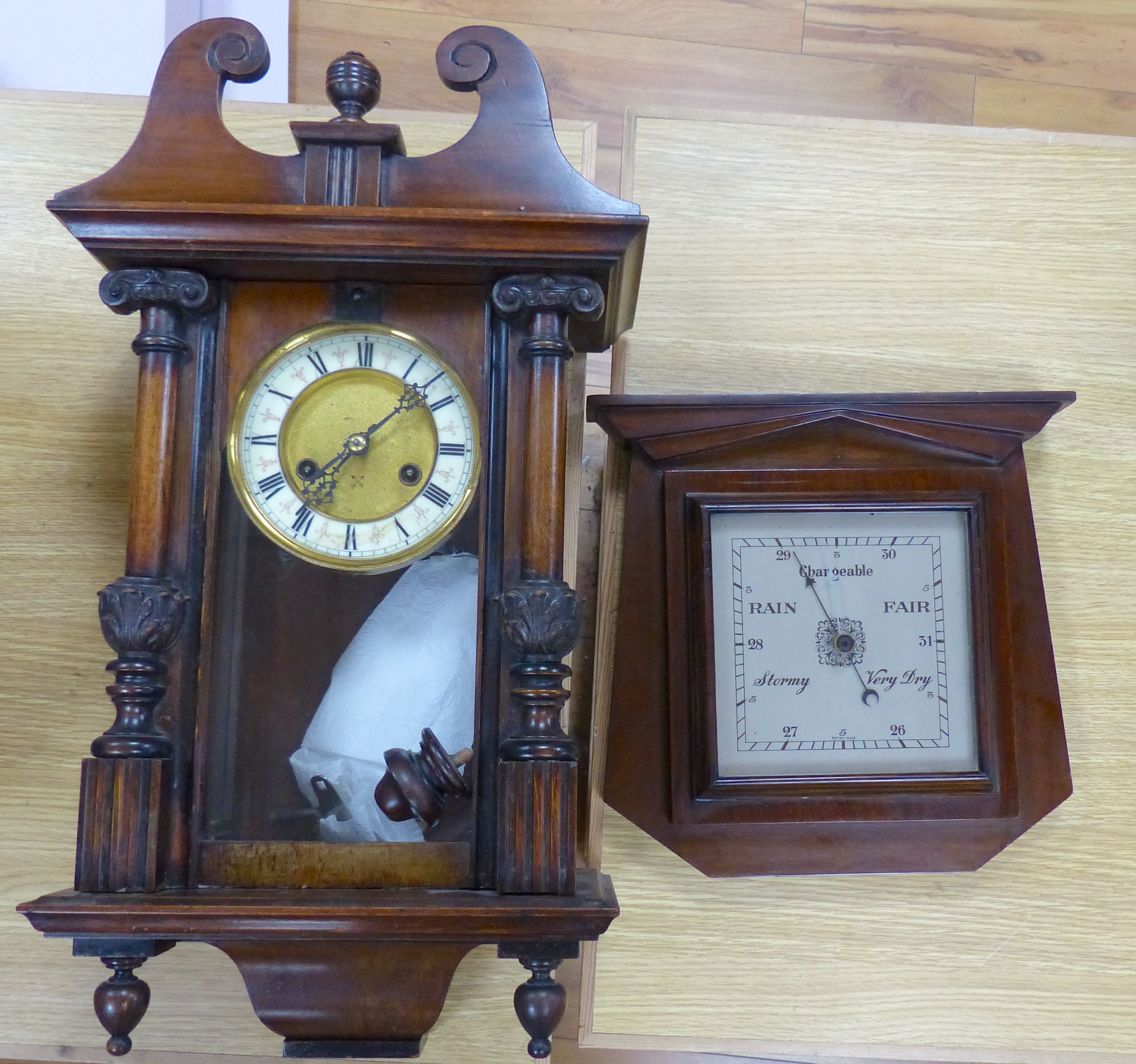 A 19th century German walnut wall clock with pendulum and key, height 58cm, and a mahogany barometer